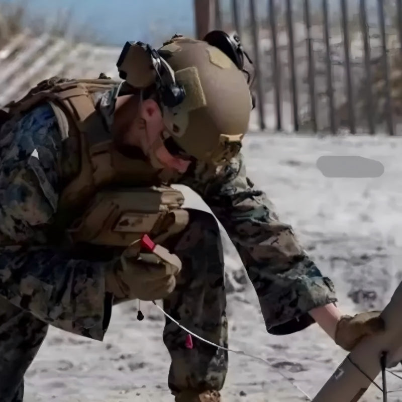 Field combat scene photo of USMC soldier wearing Coyote Brown ECH MICH2001 tactical ballistic helmet, Level IIIA aramid military combat bulletproof helmet with tactical headset, in outdoor battlefield environment